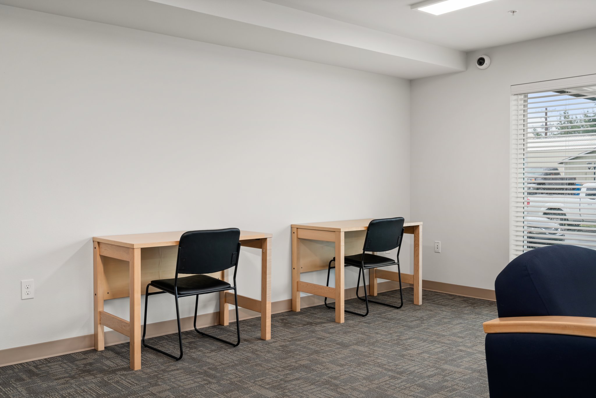 The community room has a pair of desks for collaborative study sessions.