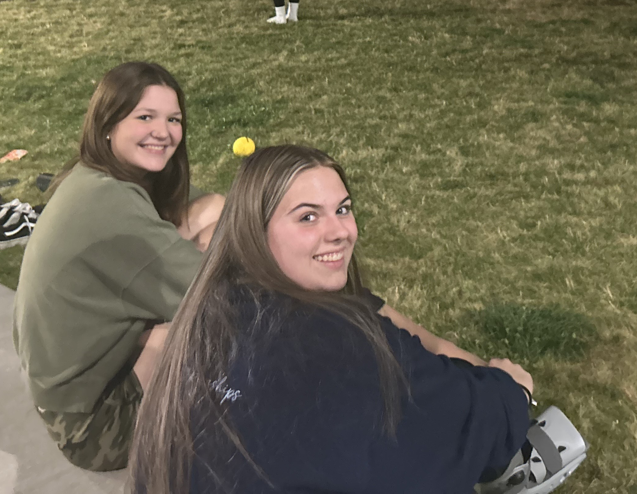 Two residents watch the Spikeball tournament.